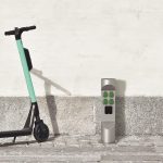 ES323EM-in-front-of-the-wall-with-e-scooter